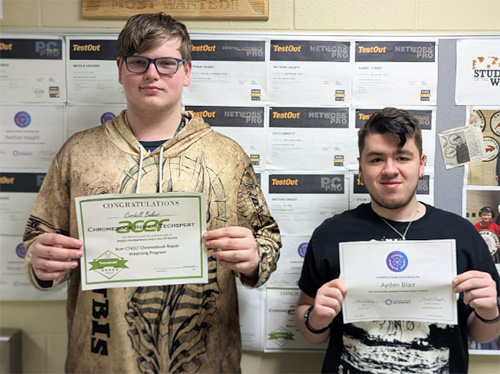 Cordell and Ayden holding up their certificates