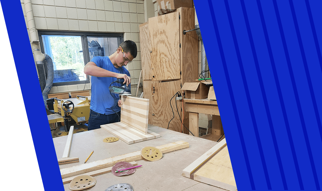 Student sanding a piece of wood