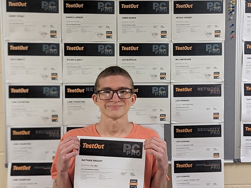 student holding his certificate