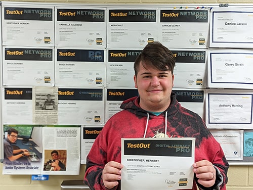 Kris Herbert holding up his certificate