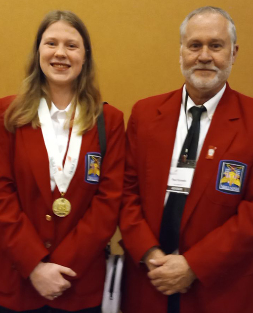 Anastasia next to a man in a blazer