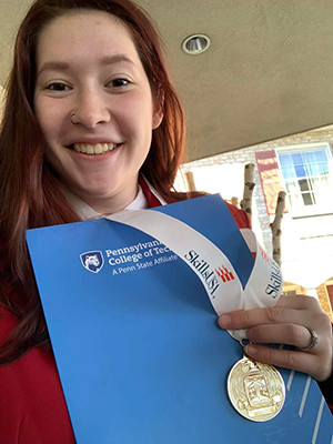 Happy student holding up an award