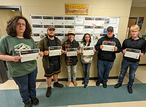 Six students holding their certificates